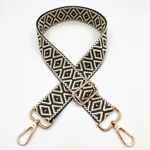 Adjustable geometric black and white jacquard woven bag strap with gold metal buckles