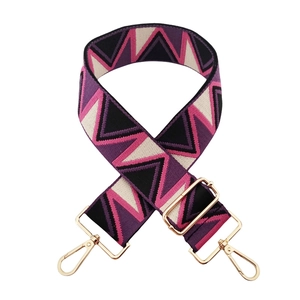 Detail of adjustable geometric jacquard strap with purple pink patterns and gold hooks