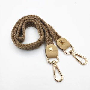Detail of knitted shoulder strap with golden sequins and swivel snap hook closure