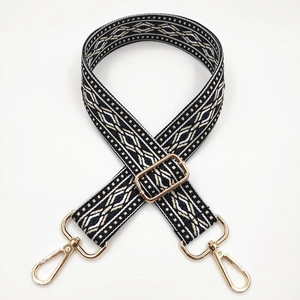 Close-up of adjustable woven shoulder strap with black and white ethnic geometric pattern
