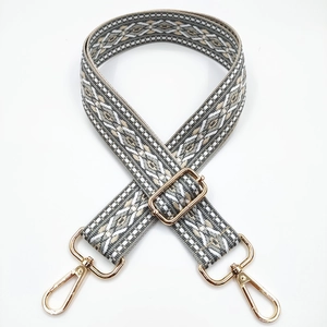 Close-up of bohemian geometric jacquard strap with adjustable gold lobster clasps