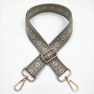 Detail of 3.8cm jacquard crossbody strap with diamond pattern and gold metal hooks