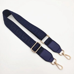 Detail of adjustable blue replacement shoulder strap with woven Greek key pattern and gold hooks