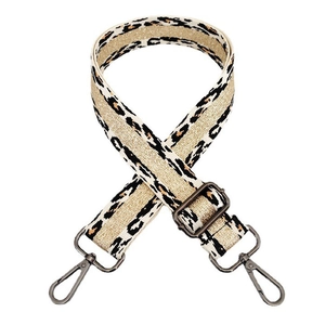 Detailed view of leopard print bag strap with adjustable gunmetal buckle and swivel hooks