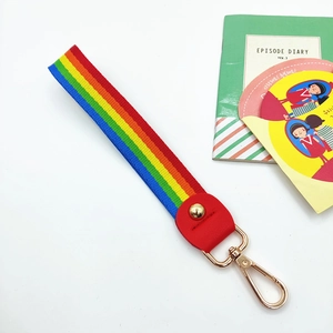 Rainbow striped wrist strap with red leather connector and gold lobster clasp