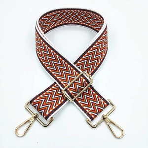 Adjustable wide shoulder strap with orange chevron pattern and gold metal buckles