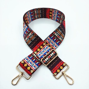 Close-up of geometric pattern strap with adjustable golden metal buckle and swivel hooks