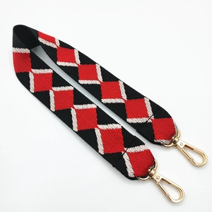 Detail of bohemian jacquard bag strap with red black geometric diamond pattern