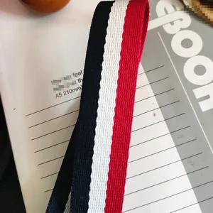 Close-up of red, white and navy striped canvas strap with twill weave texture