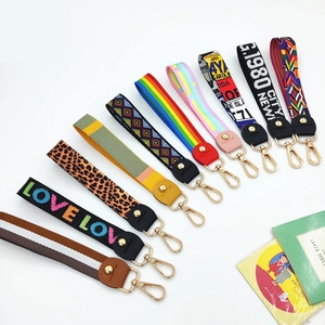 Close-up of colorful wristlet straps with golden lobster clasps in various stylish patterns
