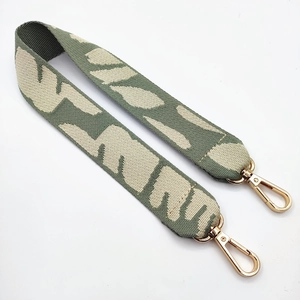 Close-up of sage green leopard jacquard strap with golden rotating lobster clasps
