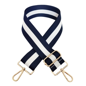 Close-up of adjustable striped handbag strap with golden metal swivel snap hooks
