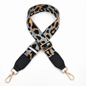 Close-up of leopard print wide strap with gold metal lobster clasps and adjustment buckle