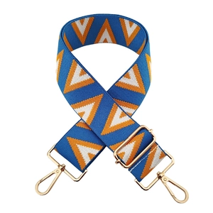 Adjustable wide jacquard bag strap with blue and orange geometric pattern and gold clips