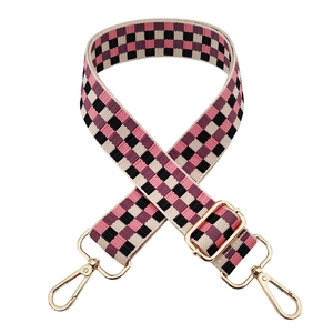 Adjustable checkerboard bag strap with pink and purple pattern and gold metal hardware