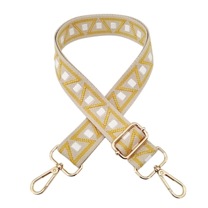 Close-up of geometric woven shoulder strap with gold-tone swivel metal hooks