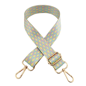 Detail of colorful fish scale pattern on wide adjustable strap with gold metal hooks