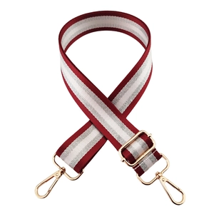 Detail of adjustable 3.8cm burgundy and silver striped wide shoulder strap with gold buckles