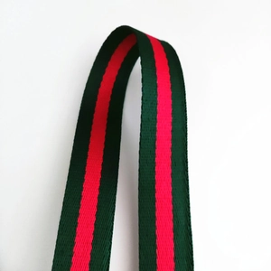 Close-up of green and red striped thick woven strap with durable nylon texture