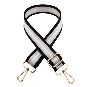 Detail of adjustable 3.8cm striped bag strap with gold metal hooks and sliding buckle