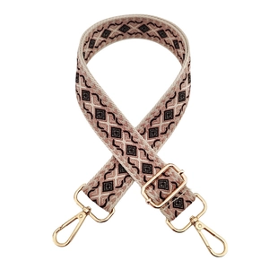 Close-up of pink diamond weave shoulder strap with gold hardware and adjustment buckle