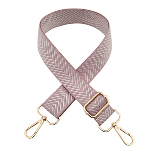 Adjustable wide pink and silver herringbone shoulder strap with golden metal hooks