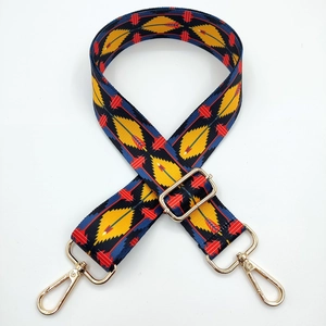 Close-up of colorful ethnic geometric wide bag strap with gold metal lobster clasps