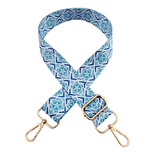 Adjustable floral pattern shoulder strap for bags with golden metal hooks on white background