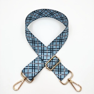 Close-up of adjustable blue plaid wide shoulder strap with gold-plated metal hardware