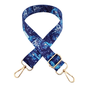 Adjustable crossbody shoulder strap featuring a blue marble pattern and gold metal hooks