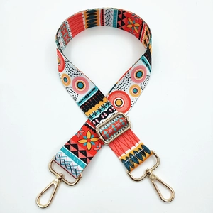 Detail of colorful ethnic pattern shoulder strap with gold metal swivel hooks and buckle