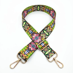 Close-up of bohemian ethnic print wide shoulder strap with gold lobster clasps and buckles