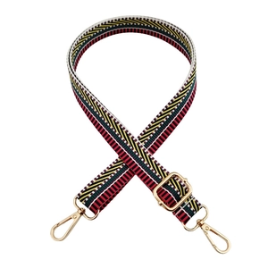 Detail of adjustable colorful nylon strap with golden metal lobster clasps and buckles