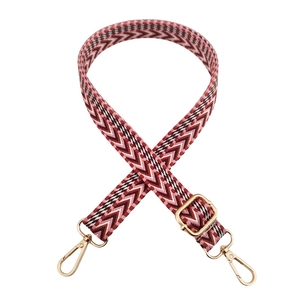 Adjustable woven strap featuring red pink and white geometric V-shaped patterns with gold buckles