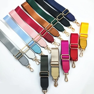 Detail of colorful nylon shoulder straps with gold hardware and PU leather ends