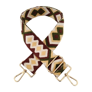 Detail of adjustable woven bag strap with olive green geometric diamond pattern and gold clips