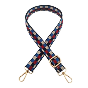 Detail of adjustable checkered strap with high-density weave and gold metal swivel hooks