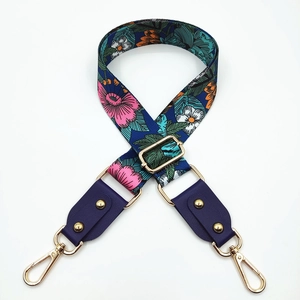 Floral print wide bag strap with purple leather ends and gold metal rotating hooks