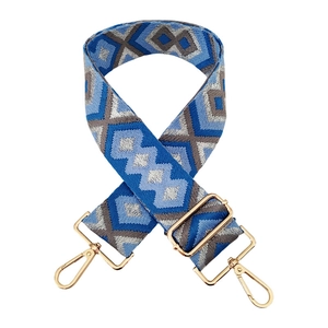 Close-up of geometric diamond embroidery on wide adjustable guitar strap with gold hardware