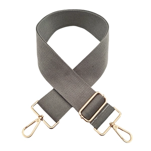 Close-up of grey 5cm wide cotton bag strap with adjustable gold metal buckles