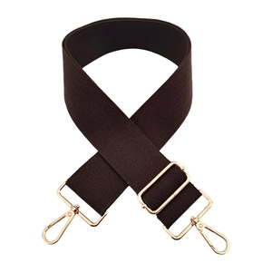 Close-up of brown 5cm wide cotton bag strap with gold lobster clasps and texture