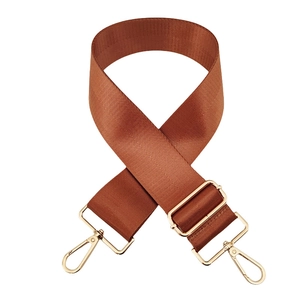 Close-up of caramel nylon bag strap with 5cm width and polished gold metal buckles