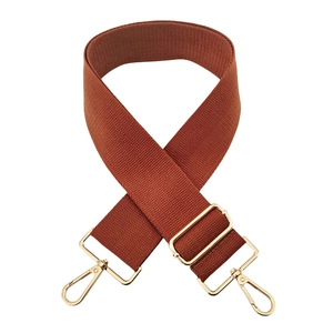 Close-up of caramel cotton shoulder strap with pale gold adjustable metal hardware