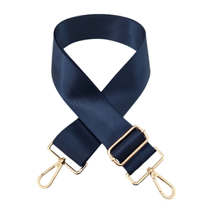 Detail of navy blue nylon shoulder strap with adjustable golden metal buckle and hooks