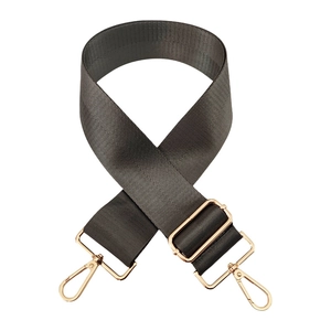 Detail of adjustable dark gray nylon wide bag strap with gold metal lobster clasps
