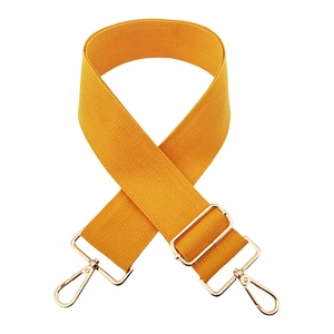 Close-up of mustard yellow canvas replacement strap with gold metal buckles for handbags