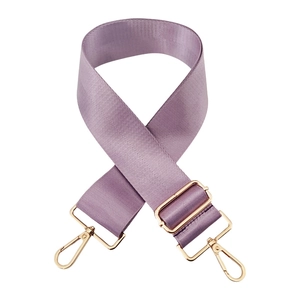 Detail of lavender nylon wide bag strap with gold metal buckle and twill texture