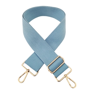 Detail of adjustable light blue wide woven replacement shoulder strap with gold metal hooks
