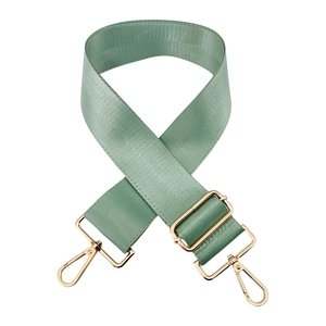 Macro shot of mint green 5cm wide nylon bag strap with polished gold metal hardware