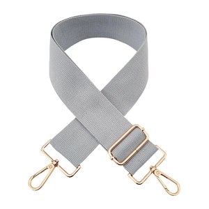 Macro shot of 5cm light gray cotton bag strap with gold metal swivel hooks and slider